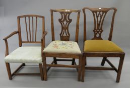 A 19th century upholstered elm armchair and two 19th century oak chairs. The former 53 cm wide.