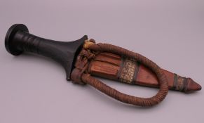 A Sudanese knife in leather sheath. Knife 23 cm long overall, blade 13 cm long.