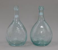 A pair of glass bottles decorated with shooting and fishing scenes. 23 cm high.