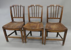 Three 19th century elm solid seated Country chairs.