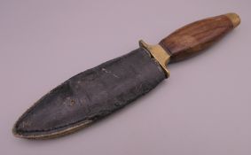 A wooden handled boot knife. 20 cm long, blade 10 cm long.