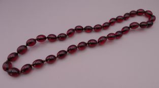 A string of beads. Approximately 56 cm long.