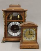 Two walnut mantle clocks. The largest 42 cm high.