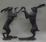 A pair of large bronze boxing hares. The largest 81 cm high.