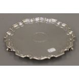 A silver salver. 25.5 cm diameter. 533.7 grammes.