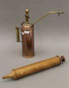 A brass and copper pump and a treen syringe. The former 40 cm high.
