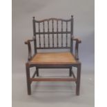 A 19th century caned seated mahogany open armchair. 61 cm wide.
