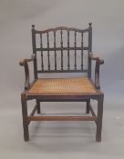 A 19th century caned seated mahogany open armchair. 61 cm wide.