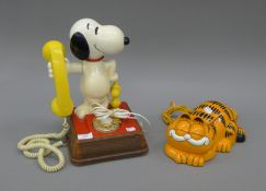 A novelty Garfield telephone and a Snoopy telephone. The latter 34 cm high.