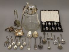 A silver plate mounted claret jug and a quantity of silver plated cutlery.