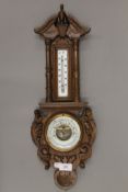 A Victorian carved oak barometer. 56.5 cm high.