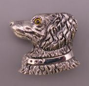 A silver dog's head form brooch. 3 cm high.