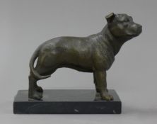 A bronze model of a dog on a marble plinth. 16 cm long.