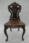 A Victorian mahogany hall chair. 45 cm wide.