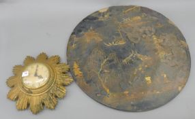 A Smiths sunburst clock, and a Jennens and Bettridge chinoiserie lacquered table top.