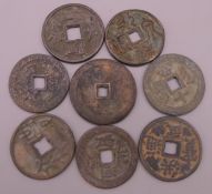Eight Chinese coins. Largest 3.5 cm diameter.