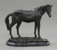 A bronze model of a horse on a marble plinth. 23 cm high.