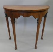 An 18th century style mahogany demi lune side table. 69 cm wide.