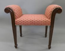 An Edwardian mahogany framed upholstered window seat. 76 cm wide.