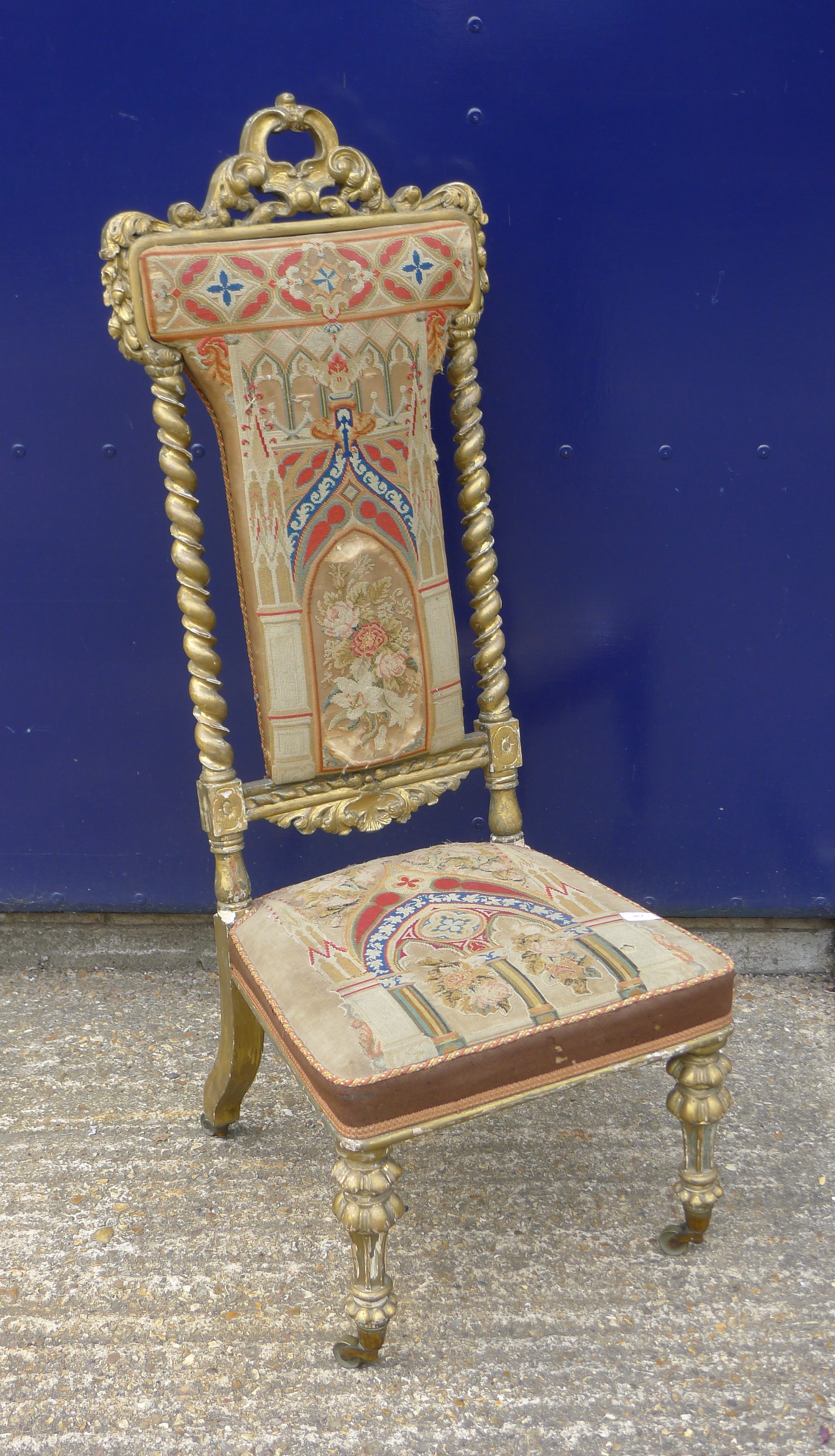 A Victorian prie dieu gilt chair with needlework upholstery. 117 cm high.