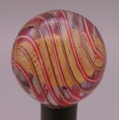 An antique glass marble. 14.5/16th of an inch diameter.