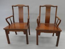 A pair of Chinese hardwood open armchairs. 53 cm wide.