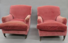 A pair of Howard style upholstered arm chairs. 76 cm wide, 79 cm high, 102 cm deep.
