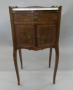 A marble top pot cupboard with lift up mirror.