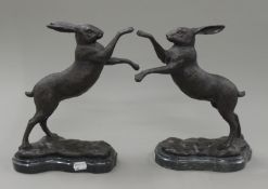 A pair of bronze boxing hares. 29 cm high.