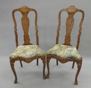 A pair of Dutch marquetry inlaid chairs. 50 cm wide.