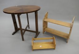 An early 20th century tilt top table, a pine shelf and an oak book rack.