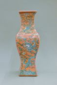 A Chinese porcelain pink ground vase decorated with a dragon. 41 cm high.