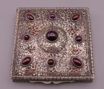 An 800 silver garnet set box. 7.5 cm square.