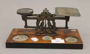 A set of Victorian postal scales, with weights. 22.5 cm wide.