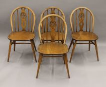 Four Ercol dining chairs.