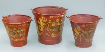 A set of three Coca Cola buckets. The largest 32 cm high.