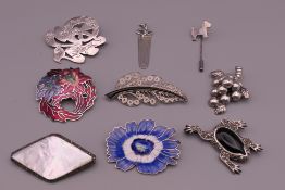 A quantity of various silver brooches and a bookmark.