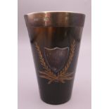 A silver rimmed carved horn beaker. 9 cm high.