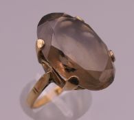 A 9 ct gold smoky quartz ring. Ring size N. 7.5 grammes total weight.