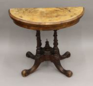 A Victorian inlaid walnut demi lune card table. 90.5 cm wide.