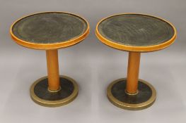 A pair of leather topped circular ships tables. 57.5 cm diameter.