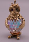 A 9 ct gold and crystal owl charm. 3 cm high. 12.8 grammes total weight.