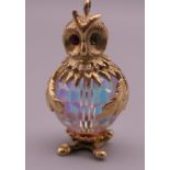 A 9 ct gold and crystal owl charm. 3 cm high. 12.8 grammes total weight.