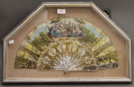 A 19th century fan with mother-of-pearl guards, housed in a box frame. 64 cm wide overall.