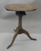 An early 18th century oak birdcage tripod table. 53 cm diameter.
