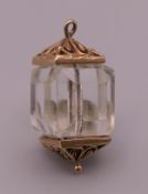 A 9 ct gold mounted crystal lantern charm. 2.6 cm high. 8.3 grammes total weight.