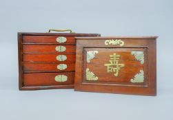 A Chinese mahjong set, in a hardwood carrying case. The case 23.5 cm wide.