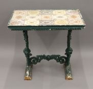 A Victorian tiled top cast iron table. 81 cm long.