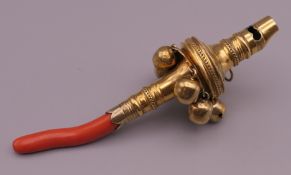 A Georgian silver gilt rattle. 12 cm long.