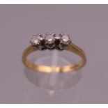 An 18 ct gold diamond trilogy ring. Ring size O. 2.6 grammes total weight.